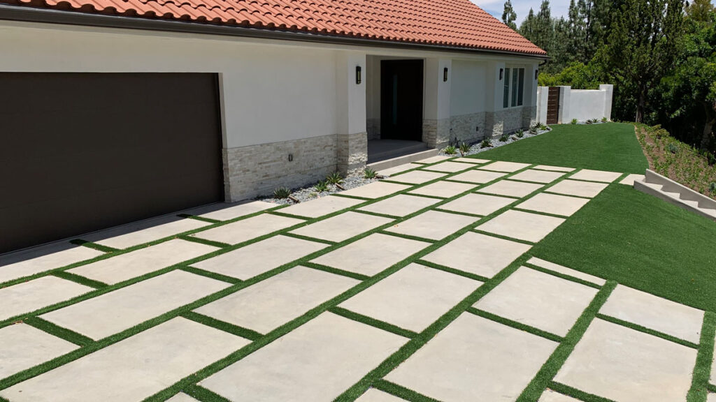 Modern driveway installation project in Los Angeles featuring large concrete pavers, landscape integration, and residential exterior hardscape renovation by JD Renovate.