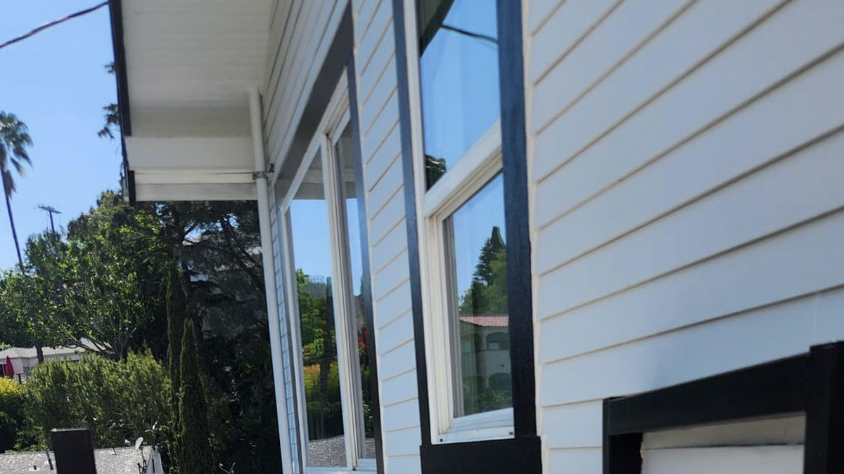 Modern home with horizontal cement siding and detailed window trim