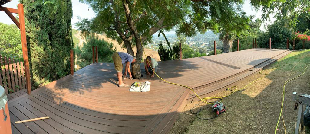 New wood deck construction with modern railing installation