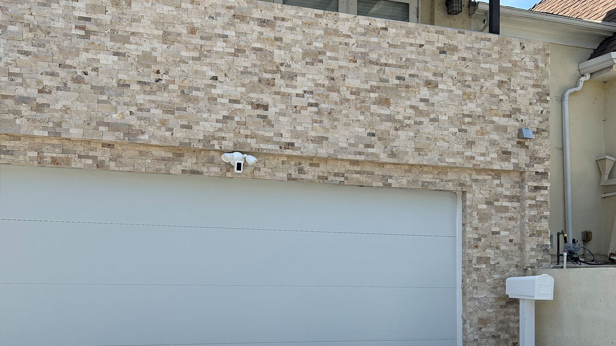 Modern stone veneer installation on residential exterior facade