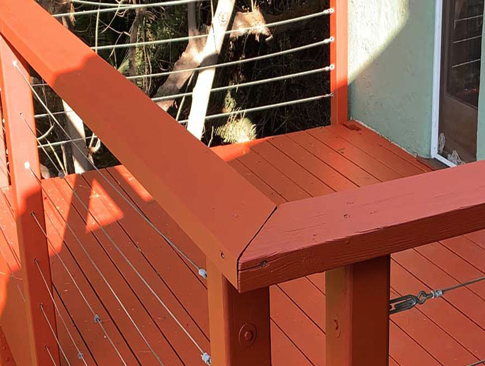 Custom outdoor deck with structural framing and glass rail installation
