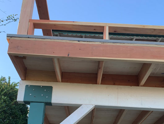 Exterior balcony addition with new support framing and custom construction details