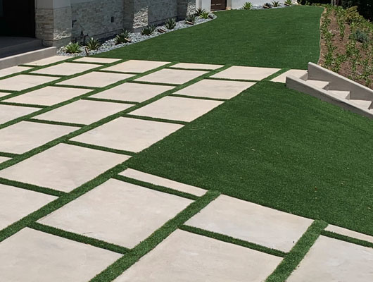 Custom concrete paver driveway with landscape integration and modern residential exterior renovation by JD Renovate
