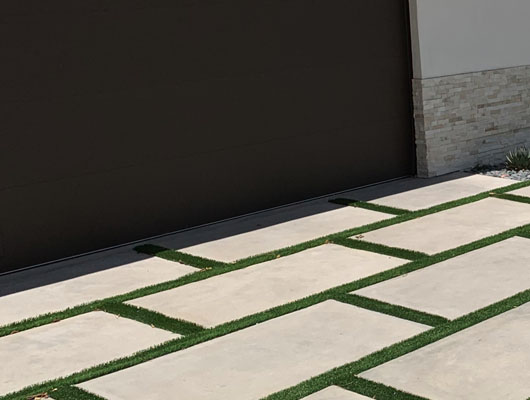 Modern concrete paver driveway installation project in Los Angeles featuring large architectural pavers and clean exterior hardscape design