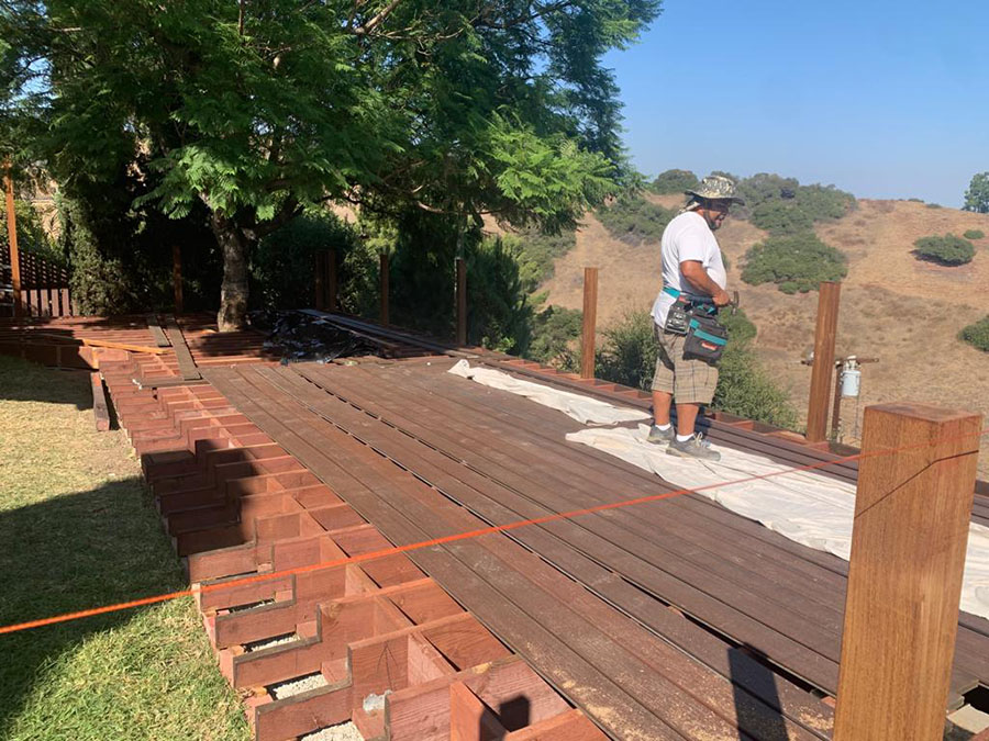 Elevated backyard deck built with structural wood framing
