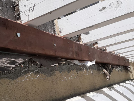Residential deck repair Los Angeles project showing exposed framing and exterior reconstruction work