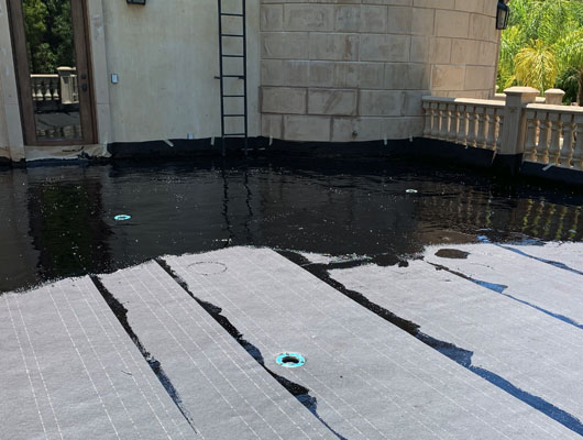 Exterior waterproof deck tile installation in Beverly Hills with hot mop waterproofing system and natural stone tile finish