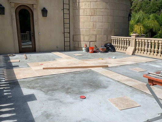 Hot mop waterproof deck tile installation Los Angeles project with exterior stone tile and moisture protection system