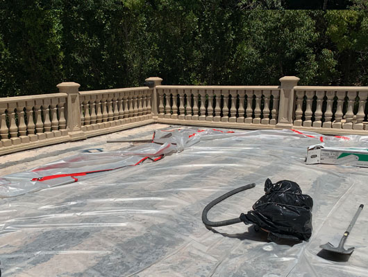 Natural stone waterproof deck tile installation featuring hot mop membrane application and exterior tile construction