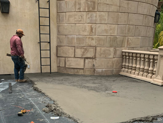 Exterior tile deck waterproofing project featuring hot mop membrane system and natural stone tile installation