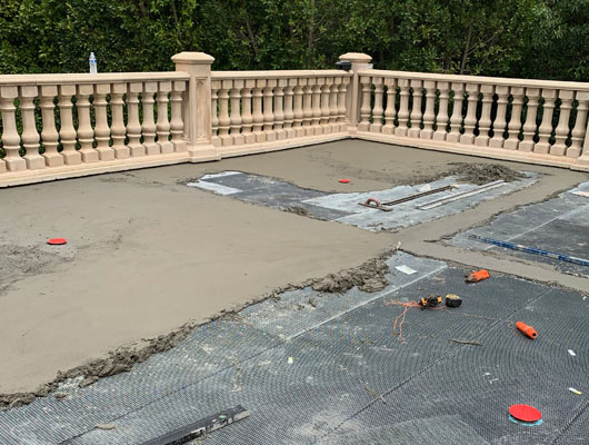 Waterproof deck tile installation project completed by JD Renovate with exterior stone tile and drainage improvements
