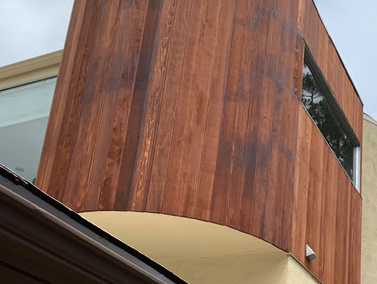 Residential wood siding installation project completed by JD Renovate featuring architectural wood paneling and exterior finish carpentry